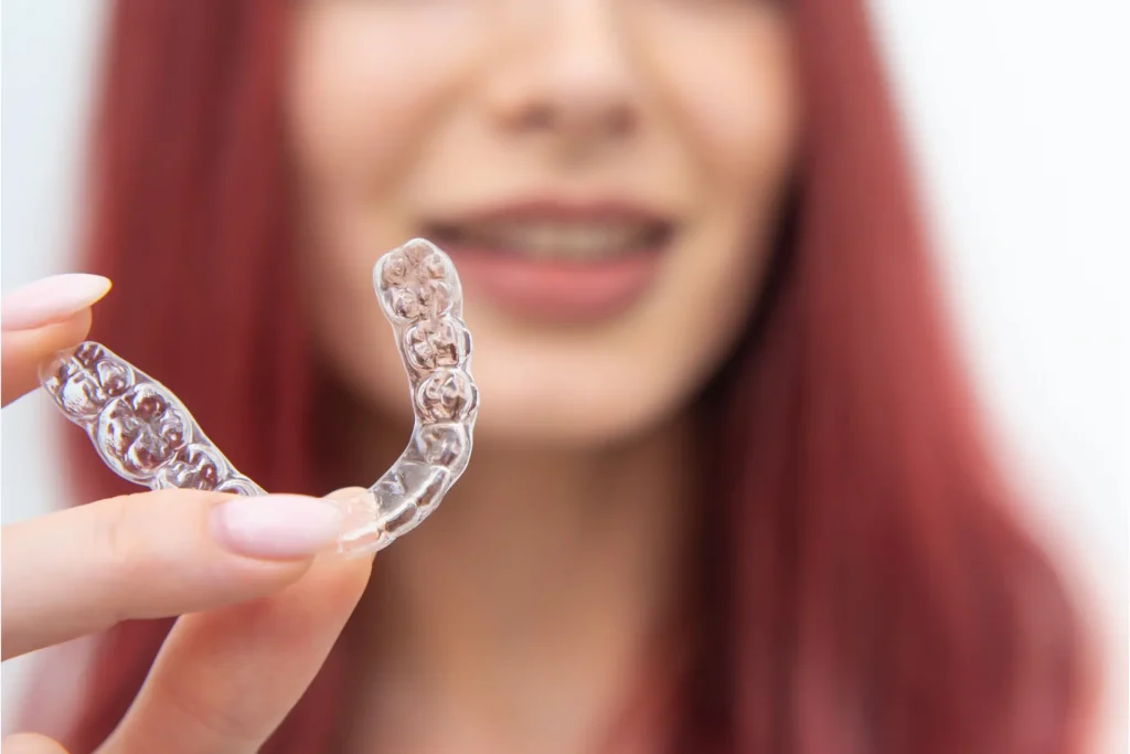 Woman showing clear aligner