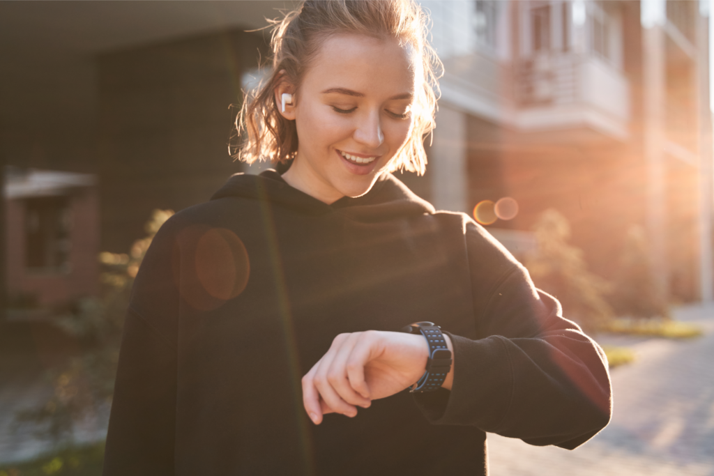woman checking results on smartwatch